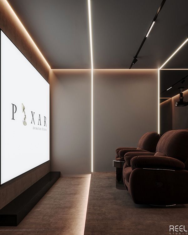 an empty theater room with two recliners and a projector screen in the corner