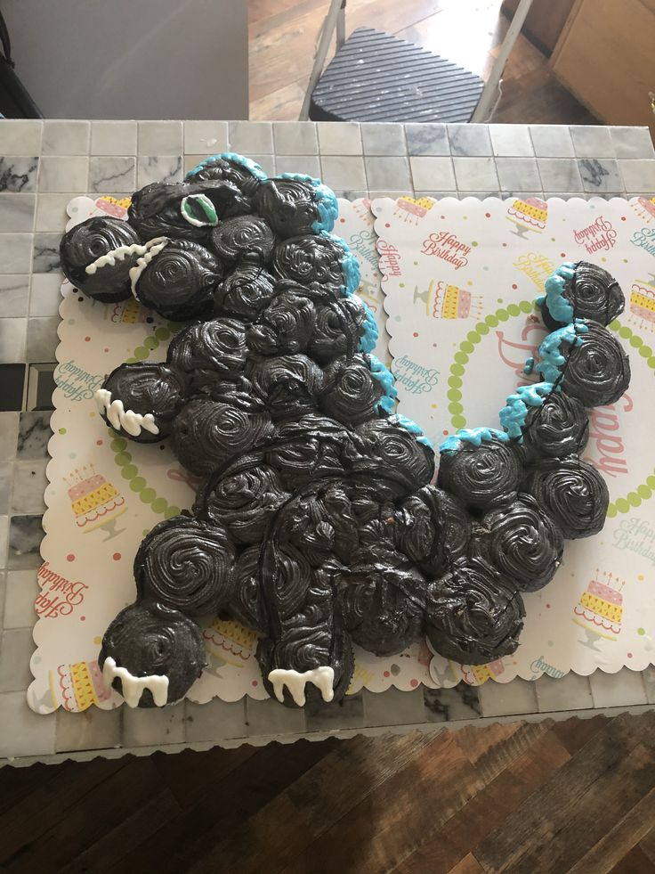 a cake made to look like an animal with blue icing on it's face