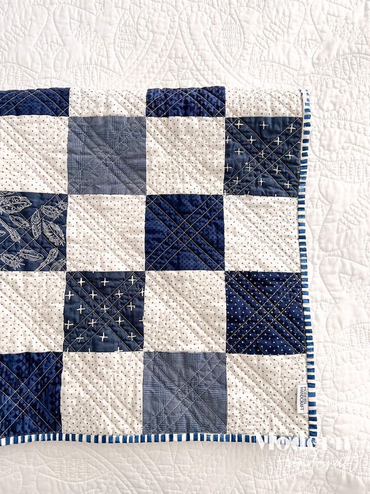 the blue and white quilt is on display