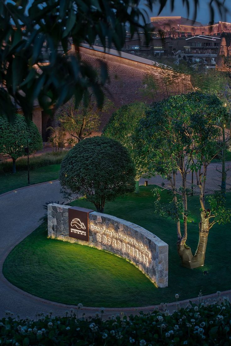 an illuminated sign in the middle of a park