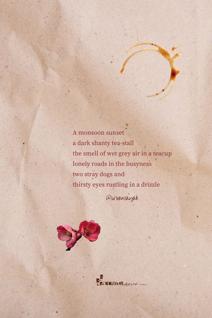 a piece of paper with a poem written on it and two flowers in the foreground