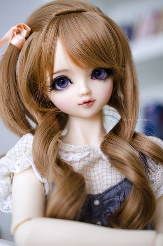 a close up of a doll with long hair