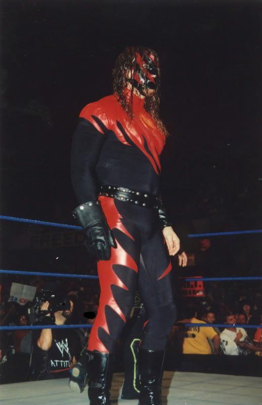 a man in a wrestling ring with his face painted red and black