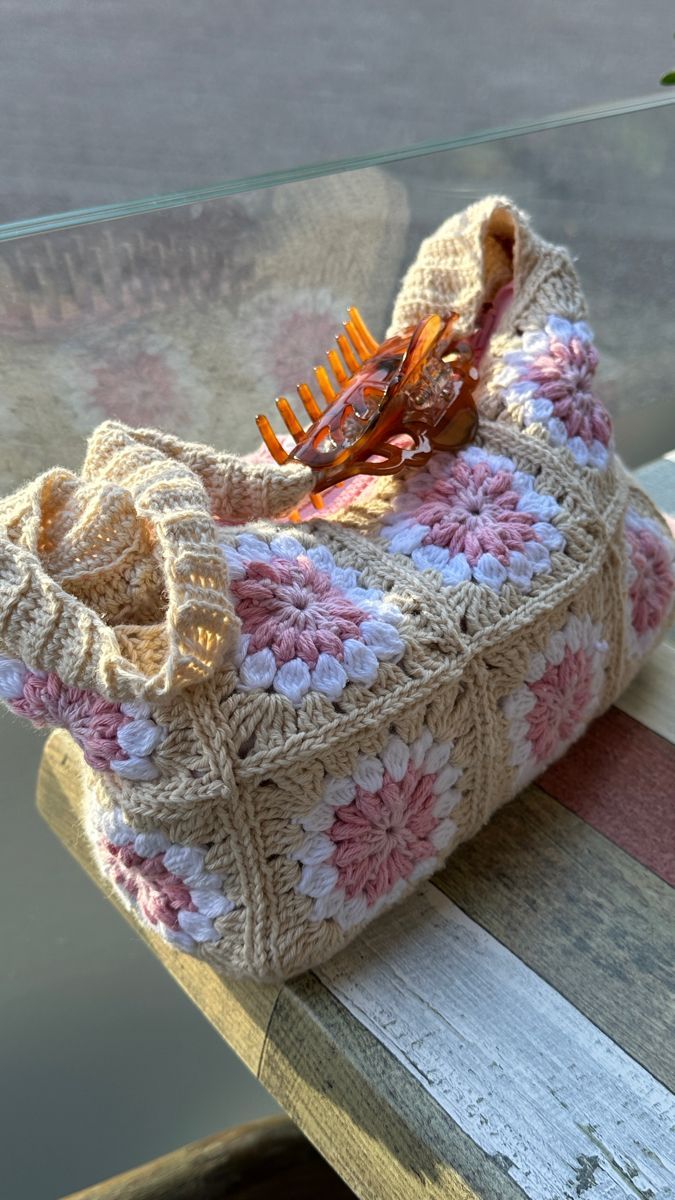 a crocheted purse sitting on top of a wooden table