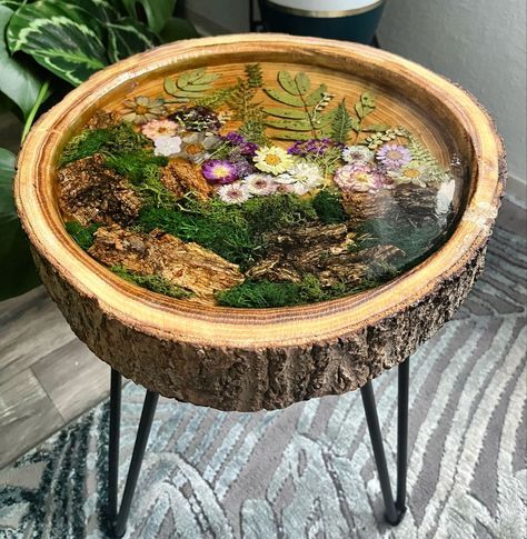 a wooden tray with flowers and plants on it
