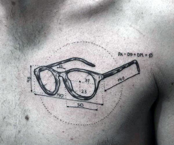 a man's chest with an eyeglass tattoo on it and measurements for the glasses