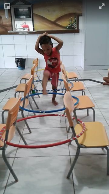 a little boy standing on top of a set of chairs