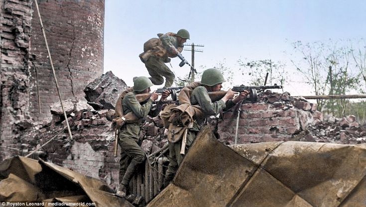 soldiers climbing up the side of a destroyed building