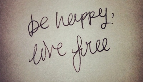 the words be happy, live free written in cursive writing on a piece of paper