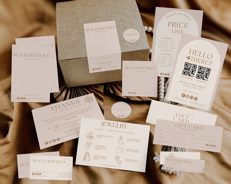 the wedding stationery is laid out neatly on the bed with its price tags and envelopes