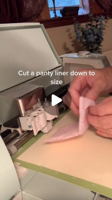 a person cutting paper with a machine in front of them that says cut a party liner down to size