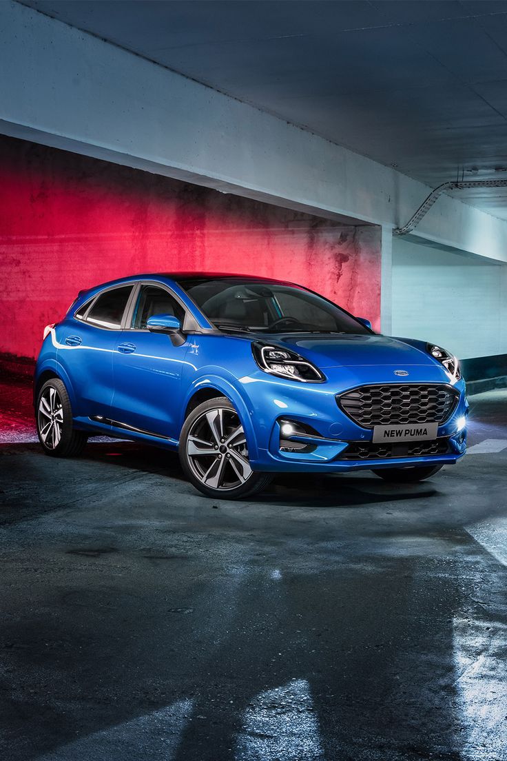 a blue car parked in a parking garage