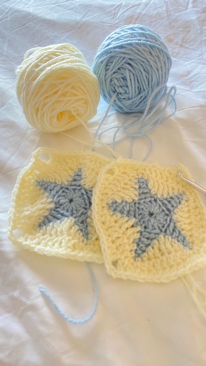 three balls of yarn and two crocheted stars