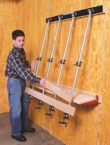 a young man is holding onto the back of a rack with four skis on it