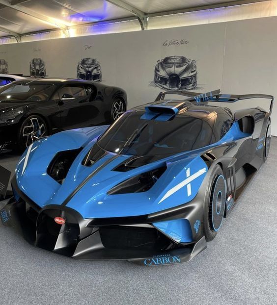 two blue and black sports cars in a showroom