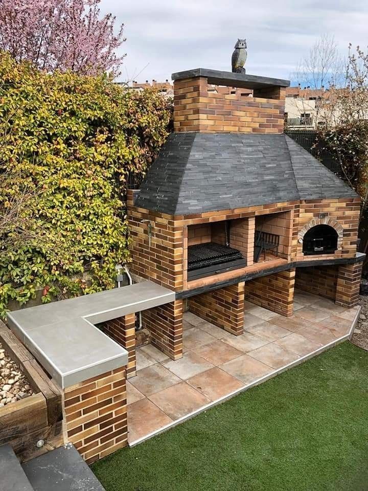 an outdoor brick pizza oven in the backyard