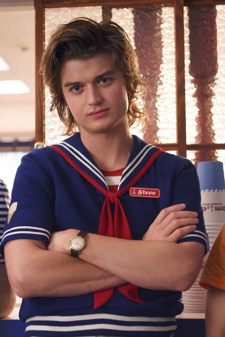 a young man with his arms crossed wearing a sailor's shirt and red tie