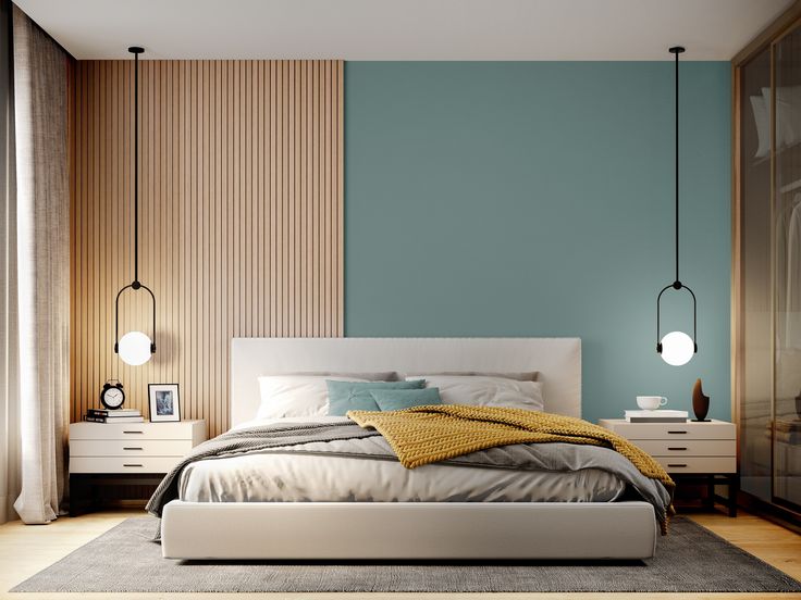 a bed sitting in a bedroom next to a wall with two lamps on each side