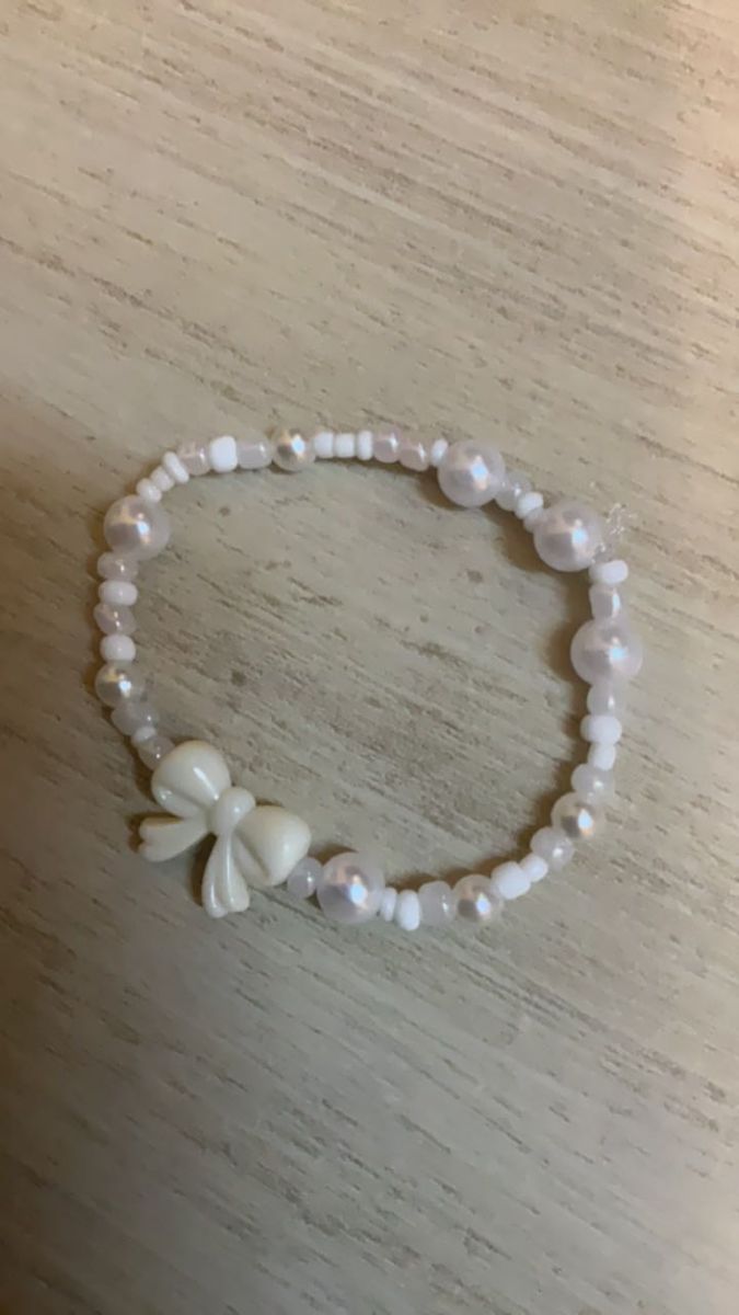 a white beaded bracelet with flowers on it