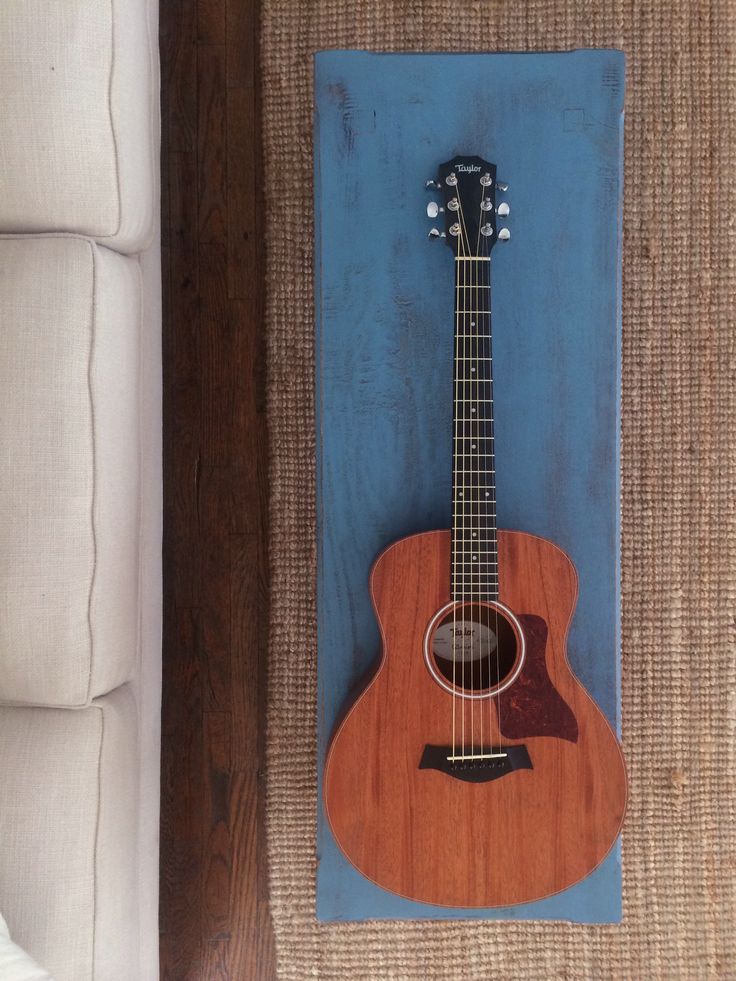 an acoustic guitar is mounted to the wall