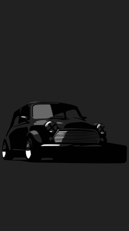 a black and white photo of a classic car on a dark background with the hood down