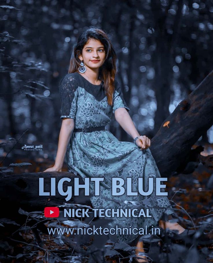 a woman sitting on top of a tree branch in the woods with text reading light blue nick technical