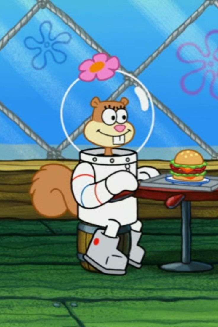 a cartoon character sitting at a table with a hamburger