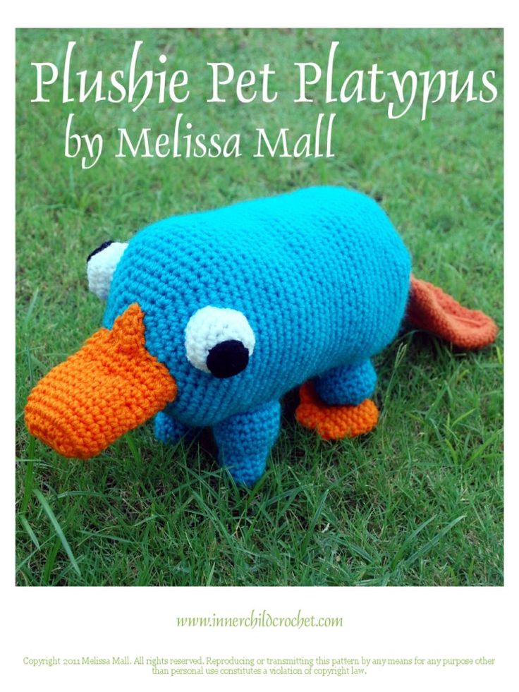 a crocheted blue stuffed animal with an orange beak