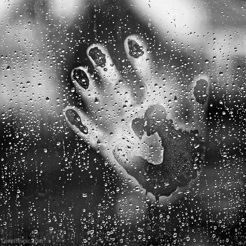 rain drops on the window and hand in black and white