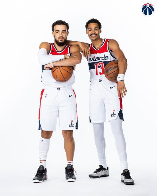 two basketball players are posing for a photo