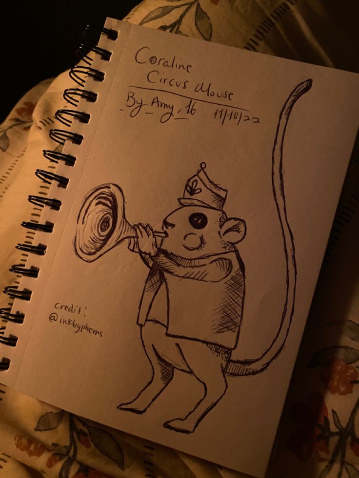 a notebook with a drawing of a mouse holding a megaphone