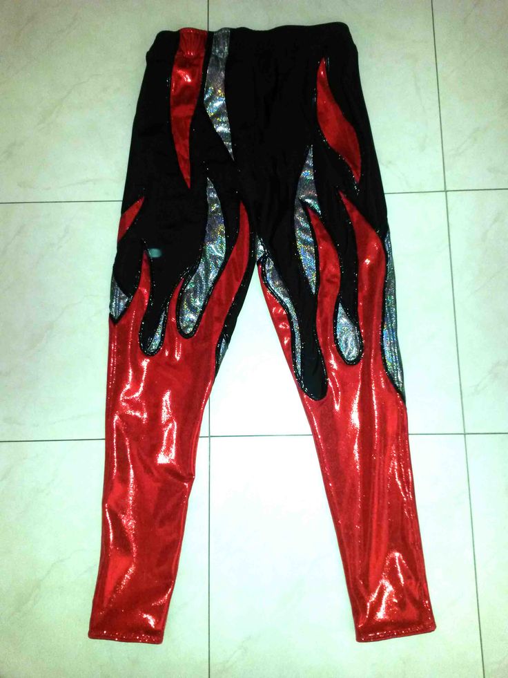 a pair of red and black leggings sitting on top of a tile floor