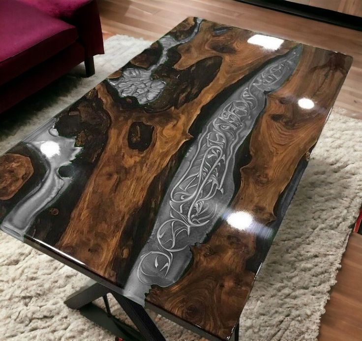a coffee table made out of wood and metal with an intricate design on the top