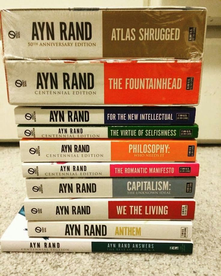 a stack of books sitting on top of a carpeted floor next to each other