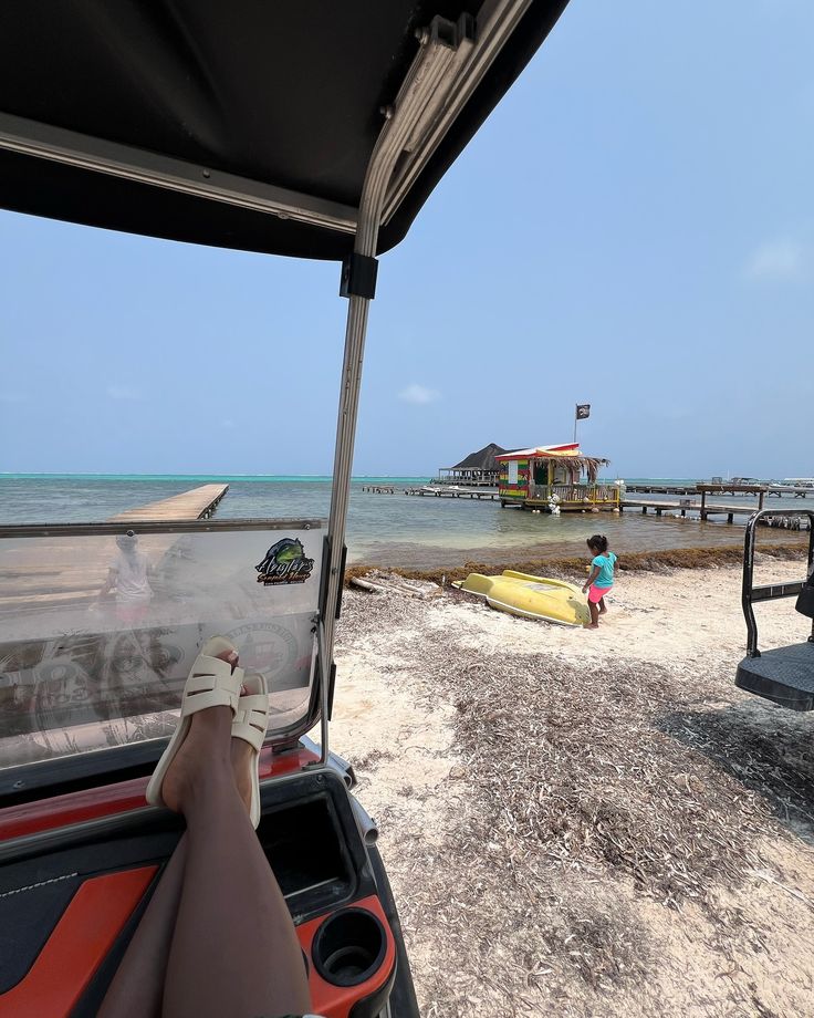 a person is sitting in a golf cart on the beach
