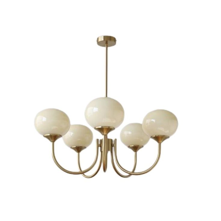 a chandelier with five white glass balls hanging from it's brass frame