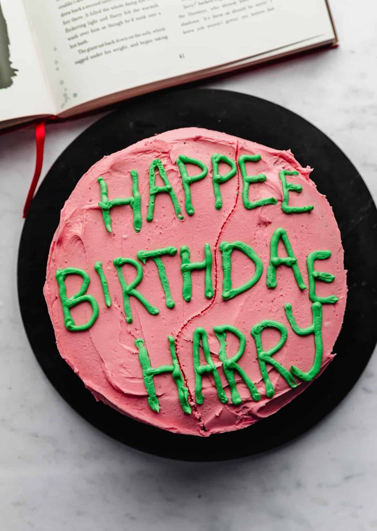 a birthday cake with the words happy birthday harry written in green frosting on it