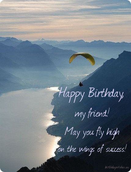 a happy birthday card with an image of a paraglider in the sky above mountains