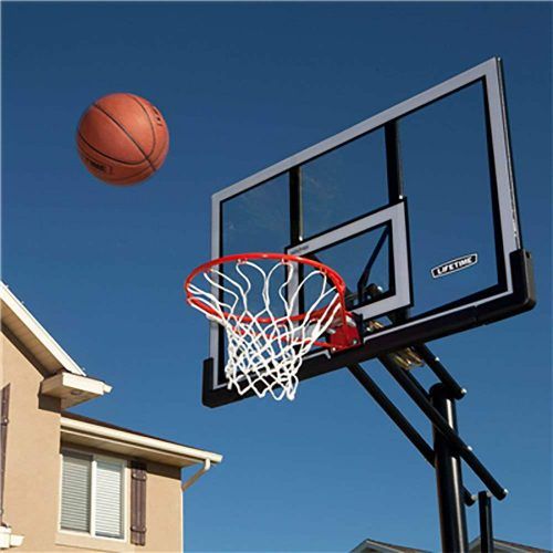 a basketball flying through the air next to a basket