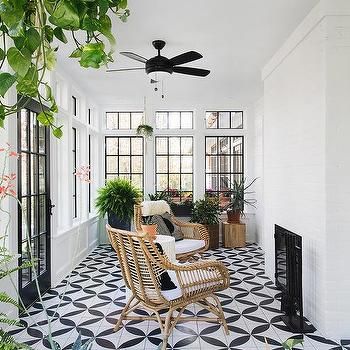 a living room with black and white tile flooring, potted plants and ceiling fan