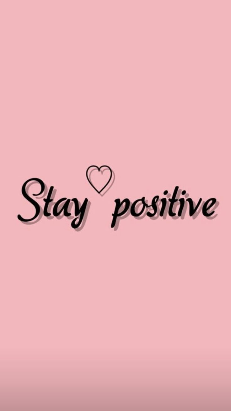 the words stay positive are written in black ink on a pink background with a heart