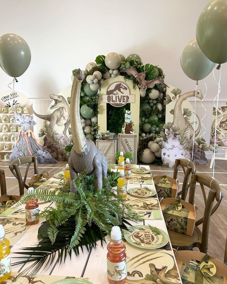 an animal themed birthday party with balloons and tableware set up for a dinosaur theme