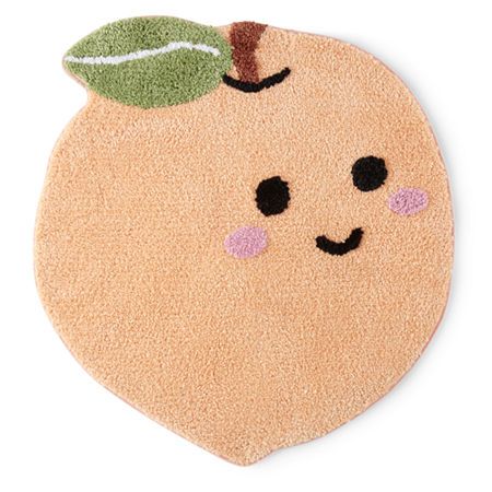 an orange shaped rug with a leaf on it's top and eyes drawn in the shape of a face