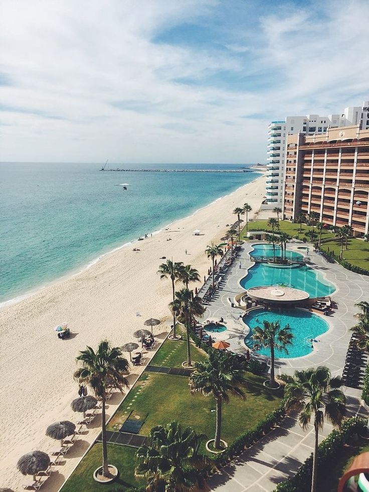 an aerial view of the beach and pool area