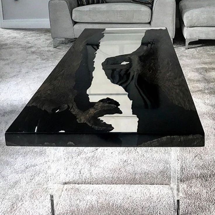 a black and white coffee table sitting on top of a carpeted living room floor