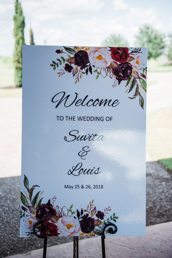 a welcome sign with flowers on it