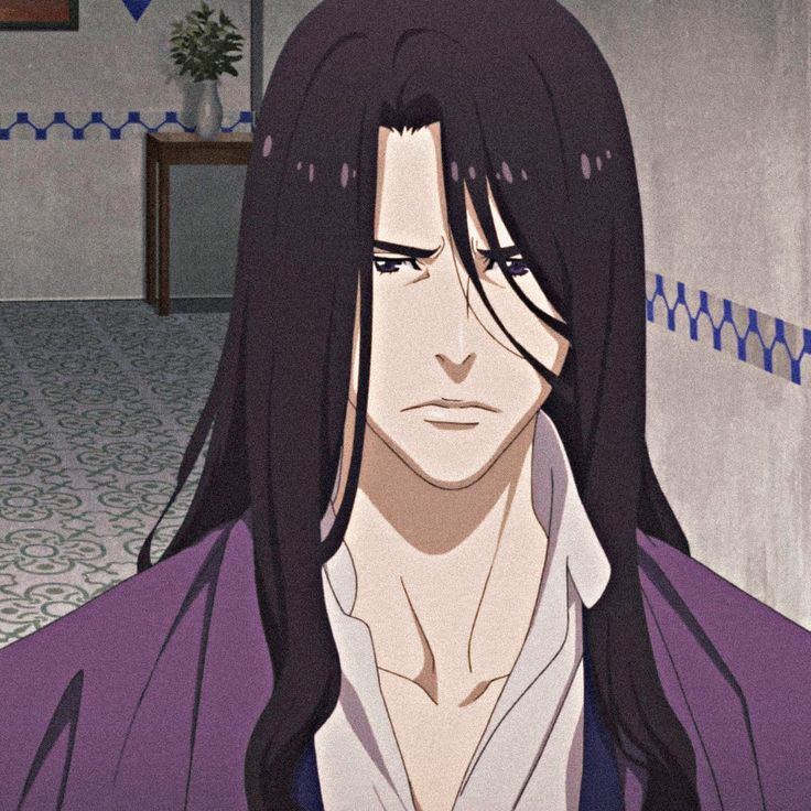 a man with long black hair wearing a purple jacket and white shirt in a room