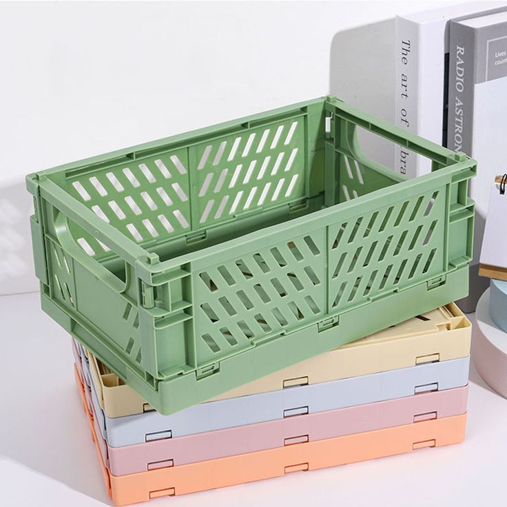 a stack of colorful boxes sitting next to each other on top of a white table