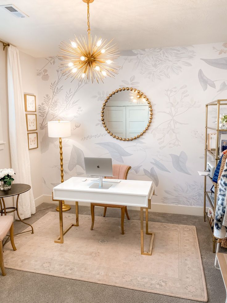 a living room with a white table and chair in front of a round mirror on the wall