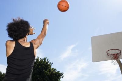 a man throwing a basketball up into the air